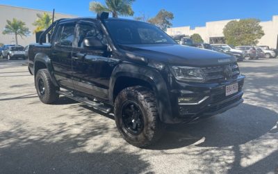 Black Volkswagen Amarok with trunk bed roll bars and M/T ATZ tires